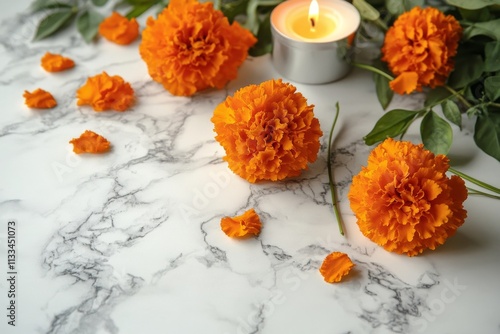 Bright orange marigolds arranged with candles on a marble surface create a se...