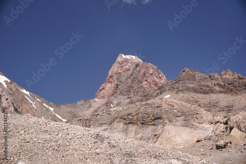 mountain landscape on a sunny day. Gray rocks and mountains covered with snow without vegetation photo