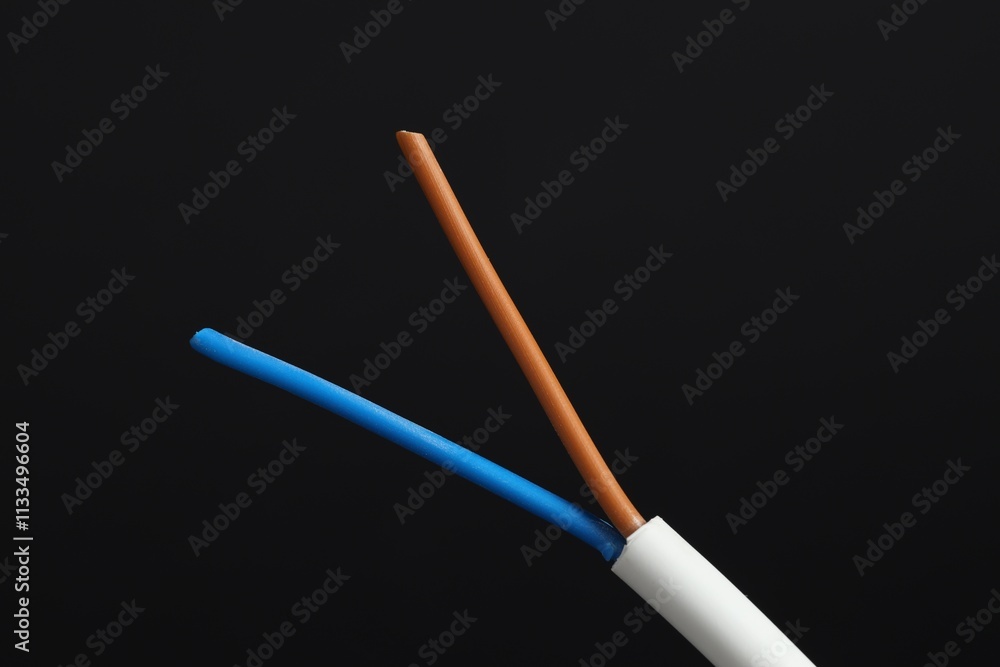 White stripped electrical wire on black background, closeup White stripped electrical wire on black background, closeup