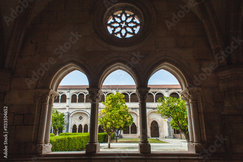 a picturesque view through a series of arched windows within a historic cloister