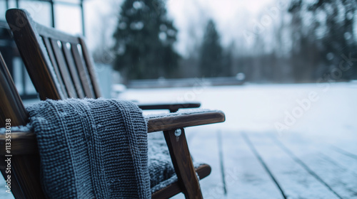 A pair of weathered wooden chairs on a snowy cafÃ© deck are made inviting with cozy knitted blankets, promising warmth in the crisp winter air. photo