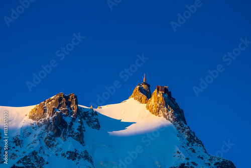 Aiguille du Midi peak in the Alps. Chamonix valley landscape of a prominent rocky towering mountain peak in french Alps. Chamonix-Montblanc area beautiful landscape of Aiguille du Midi summit