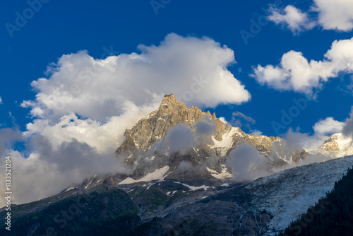 Aiguille du Midi peak in the Alps. Chamonix valley landscape of a prominent rocky towering mountain peak in french Alps. Chamonix-Montblanc area beautiful landscape of Aiguille du Midi summit