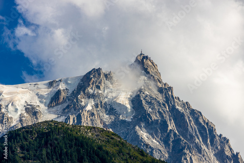 Aiguille du Midi peak in the Alps. Chamonix valley landscape of a prominent rocky towering mountain peak in french Alps. Chamonix-Montblanc area beautiful landscape of Aiguille du Midi summit