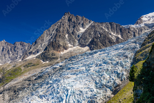 Aiguille du Midi peak in the Alps. Chamonix valley landscape of a prominent rocky towering mountain peak in french Alps. Chamonix-Montblanc area beautiful landscape of Aiguille du Midi summit
