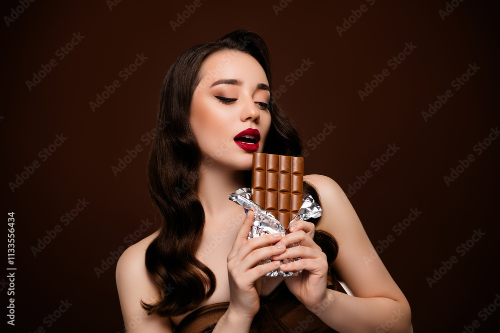 Photo of lovely gorgeous lady eat chocolate bar confectionery promo isolated on brown color background Photo of lovely gorgeous lady eat chocolate bar confectionery promo isolated on brown color background