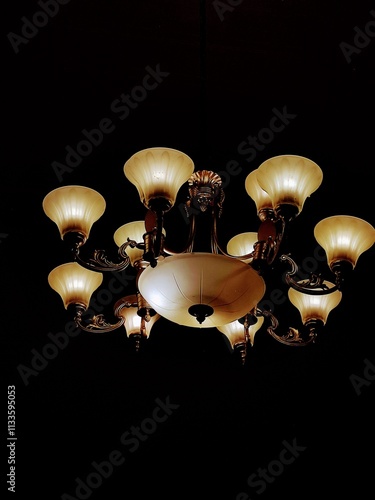 Classic and vintage chandeliers in the dark room. Copy space for background. photo