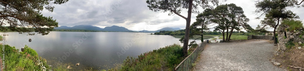 Scenic view of a tranquil lake and majestic mountains Scenic view of a tranquil lake and majestic mountains