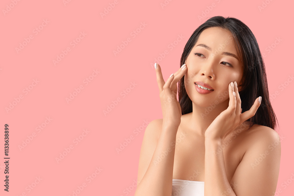 Beautiful Asian woman with healthy skin on pink background Beautiful Asian woman with healthy skin on pink background