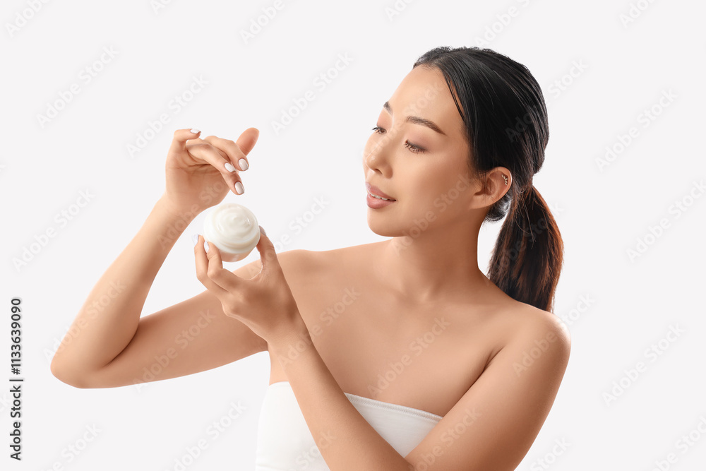 Beautiful Asian woman with cosmetic cream on white background Beautiful Asian woman with cosmetic cream on white background