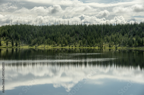 Puffy Clouds Reflect In Cascade Lake In Yellowstone photo