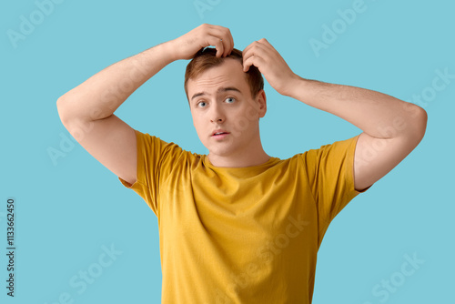 Worried young redhead man w...