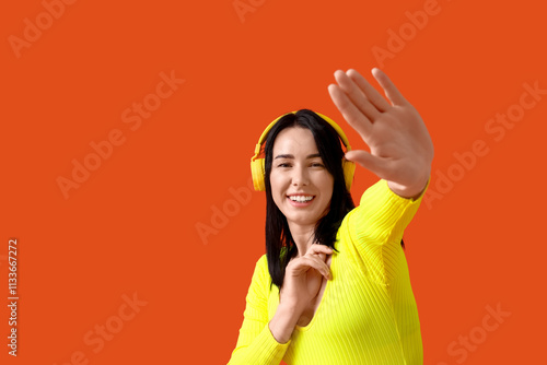Happy young woman in headph...