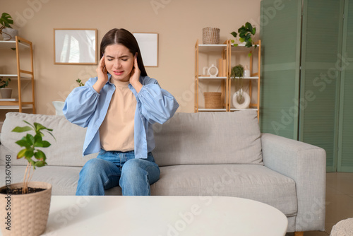 Young woman feeling pain in...