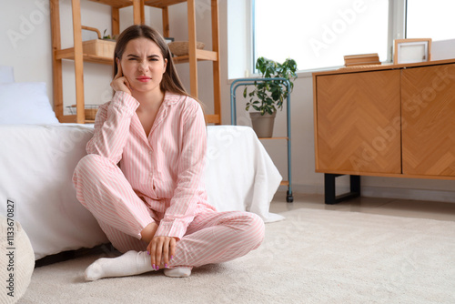 Young woman with otitis in ...