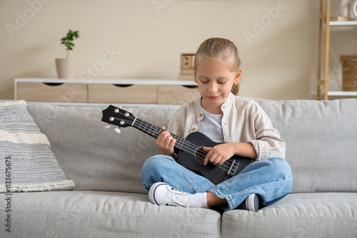 Little girl playing guitar ...