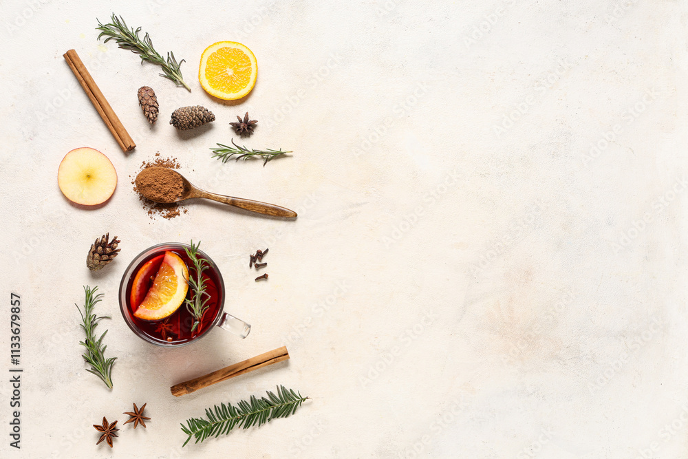 Beautiful composition with cup of tasty mulled wine and ingredients on light grunge background Beautiful composition with cup of tasty mulled wine and ingredients on light grunge background