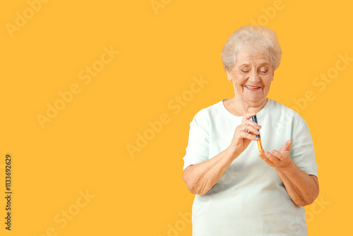 Smiling senior woman using ...