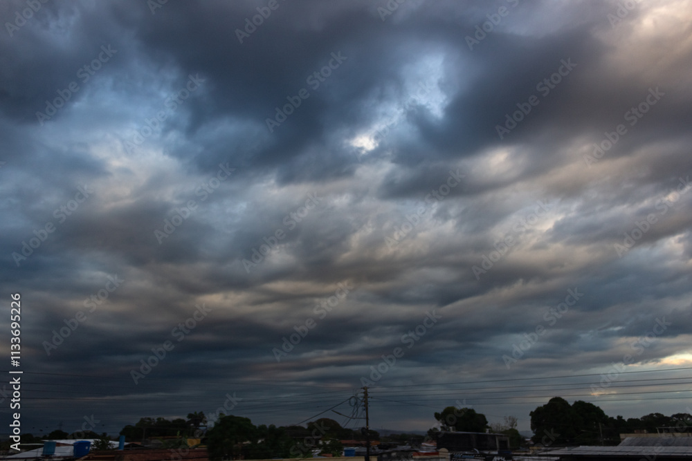 Dramatic sky with dark clouds at sunset. Nature background. Dramatic sky with dark clouds at sunset. Nature background.