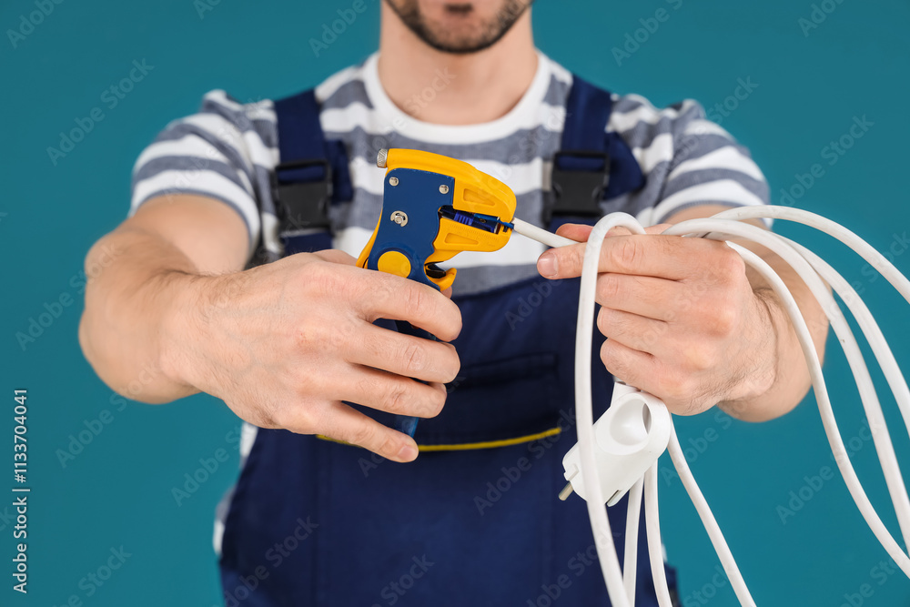 Male technician with wire stripper on blue background, closeup Male technician with wire stripper on blue background, closeup