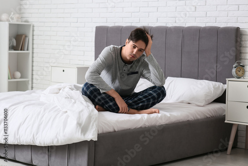 Depressed young man sitting...