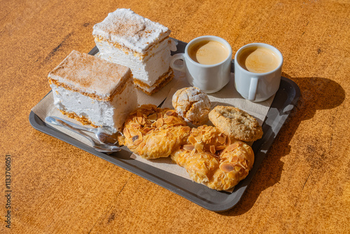 Sitting in a bakery outside eating almond sweats and drinking coffee in tejeda, spain. with Roque Bentayga in the background, Gran Canaria, Canary Islands, Spain near the Roque Nublo in the Mountains.