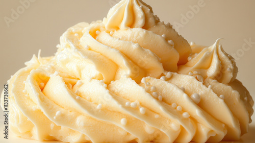 Creamy buttercream frosting with decorative swirls and sprinkles photo