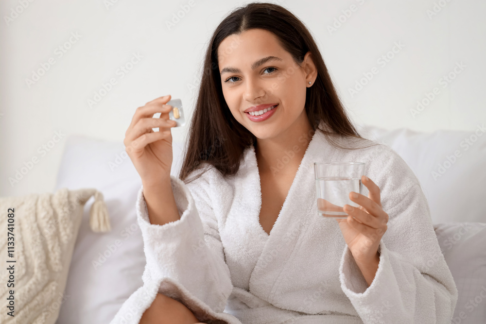 Young woman with estrogen pill and glass of water in bedroom Young woman with estrogen pill and glass of water in bedroom