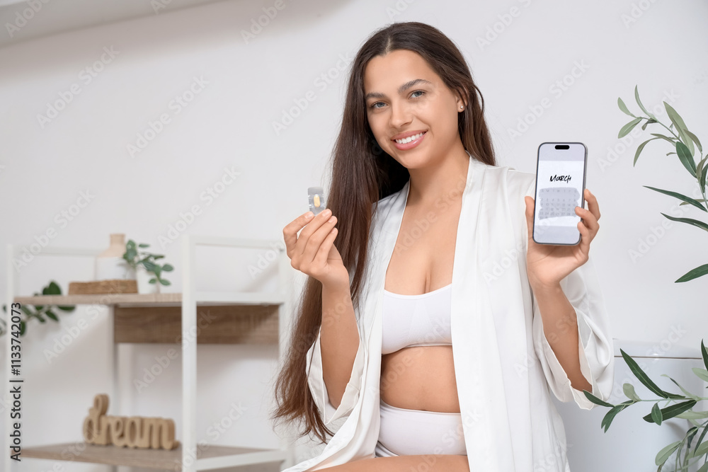 Young woman with estrogen pill and menstrual calendar on mobile phone in bathroom Young woman with estrogen pill and menstrual calendar on mobile phone in bathroom