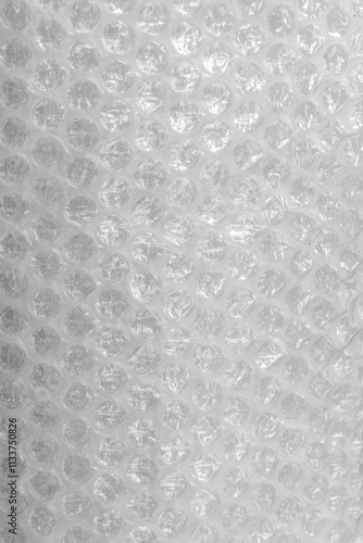 Close up view of bubble wrap, a common packing material. The image showcases the distinctive pattern of air-filled bubbles, which are designed to protect delicate items during shipping