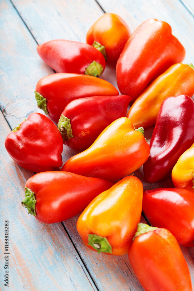 Ripe Red and Orange Bell Peppers Capsicum on Wooden Boards for Vegan Recipes Ripe Red and Orange Bell Peppers Capsicum on Wooden Boards for Vegan Recipes