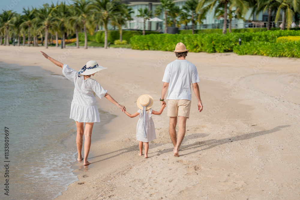 Happy family enjoying vacation on the beach together having fun on summer vacation.