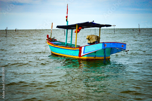 traditional wooden boat owned by Indonesian fishers in the middle of the sea .Focus on boat , Noisy, exposure, similar others