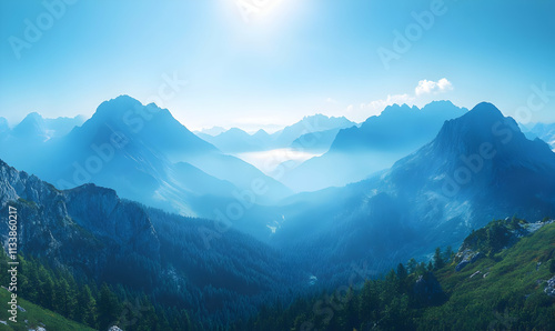 Serene mountain landscape with mist and soft sunlight creating a tranquil atmosphere.