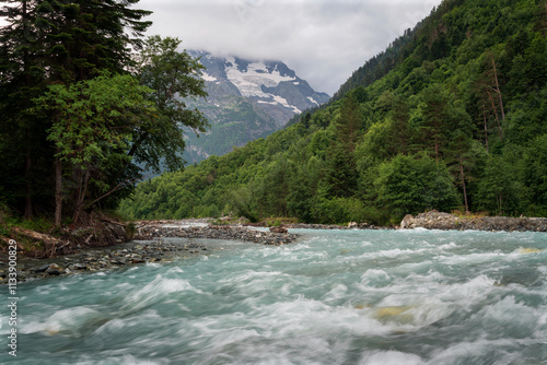 View of the Psysh River and the Amanauz-Bashi Mountain of the Northern Caucasus Mountains near the village of Arkhyz on a sunny summer day, Karachay-Cherkessia, Russia photo