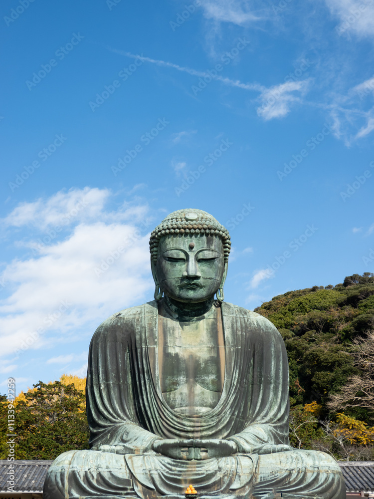 Great Buddha of Kamakura Daibutsu bronze statue seated outdoors, surrounded by lush greenery and a clear blue sky, symbolizing peace and tranquility in Kotoku-in Temple, Kanagawa, Japan Great Buddha of Kamakura Daibutsu bronze statue seated outdoors, surrounded by lush greenery and a clear blue sky, symbolizing peace and tranquility in Kotoku-in Temple, Kanagawa, Japan