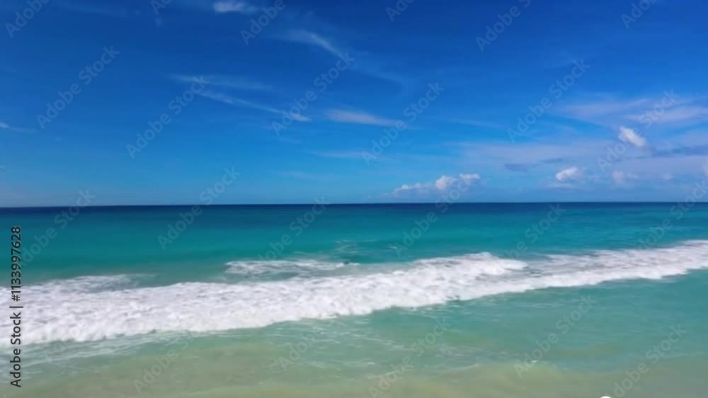A beautiful beach coastline on a sunny afternoon with bright blue skies and turquoise blue water video A beautiful beach coastline on a sunny afternoon with bright blue skies and turquoise blue water video