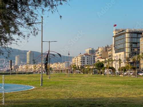 View of Kordon Street, ferry pier and high-rise buildings from the sea in Izmir Passport area photo