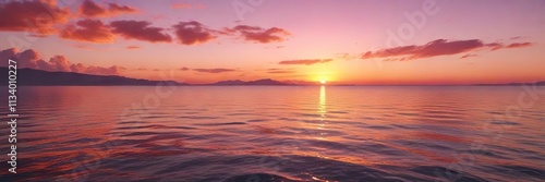 Radiant orange and pink hues of sunset on a calm sea, reflected colors, natural light