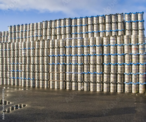 Stacked metal beer casks in yard photo