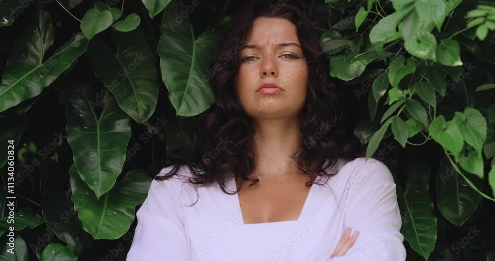A striking brunette woman in a white outfit standing with arms crossed, exuding confidence and poise amidst lush tropical foliage. Ideal for bold fashion, empowerment, and lifestyle projects. A striking brunette woman in a white outfit standing with arms crossed, exuding confidence and poise amidst lush tropical foliage. Ideal for bold fashion, empowerment, and lifestyle projects.