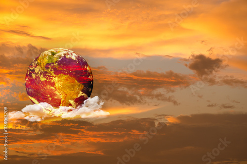 Globe on golden and red sky background. photo