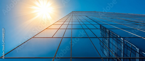 Skyscraper reflecting sunlight against a clear blue sky.