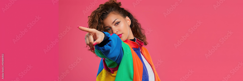 Confident woman in bold, colorful clothing looking sideways with sunglasses against a pink background Confident woman in bold, colorful clothing looking sideways with sunglasses against a pink background