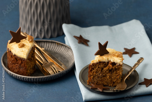 Two slices of carrot cake with serviette and chocolate stars 