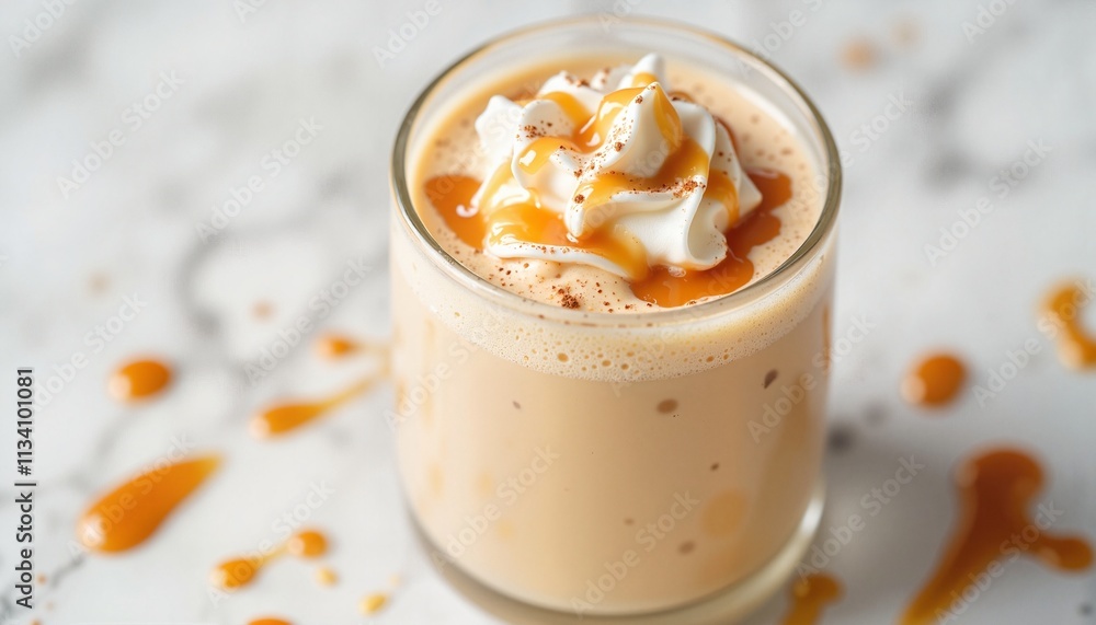 Delicate caramel milkshake with whipped cream and caramel drizzle on a marble surface Delicate caramel milkshake with whipped cream and caramel drizzle on a marble surface