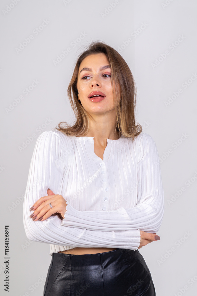 Close-up portrait of attractive brunette young woman standing on a white background. Copy space Close-up portrait of attractive brunette young woman standing on a white background. Copy space
