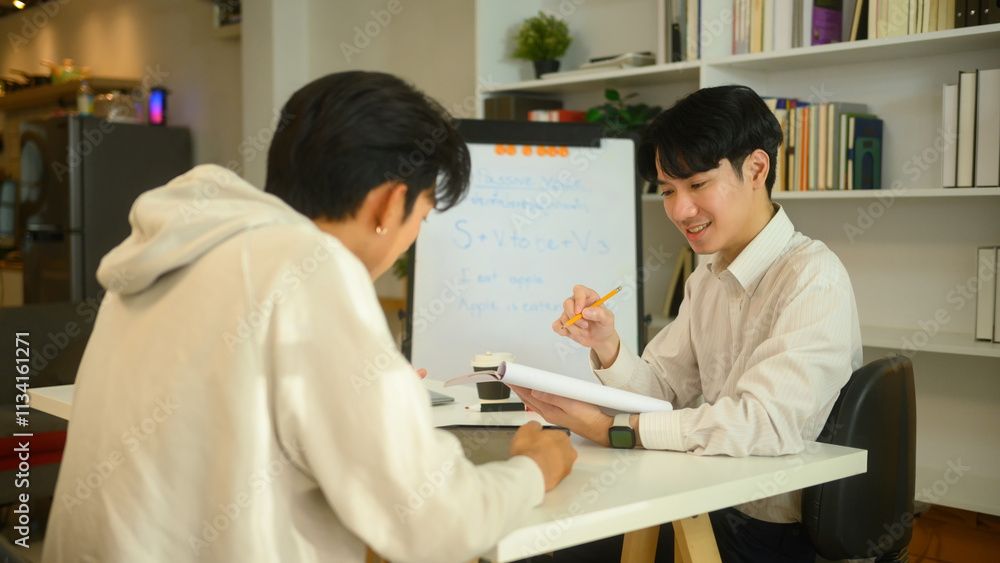 Friendly tutor explaining to student during a private lesson. Education, knowledge and tutoring concept Friendly tutor explaining to student during a private lesson. Education, knowledge and tutoring concept