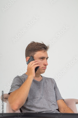 Картината върху платно A distrustful young man speaks on the phone