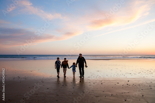 Portrait silhouettes of three children and dad happy kids with father on beach at sunset. happy family, Man, two school boys and one little preschool girl. Siblings having fun together. Bonding photo